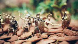 Toy warriors holding arrows in conflict